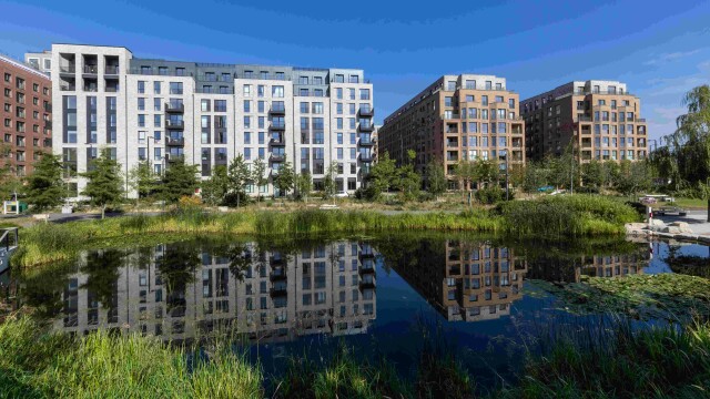 Photo of new apartments at Brent Cross Town, North London, with parkland and a lake in the foreground. (Brent Cross Town)