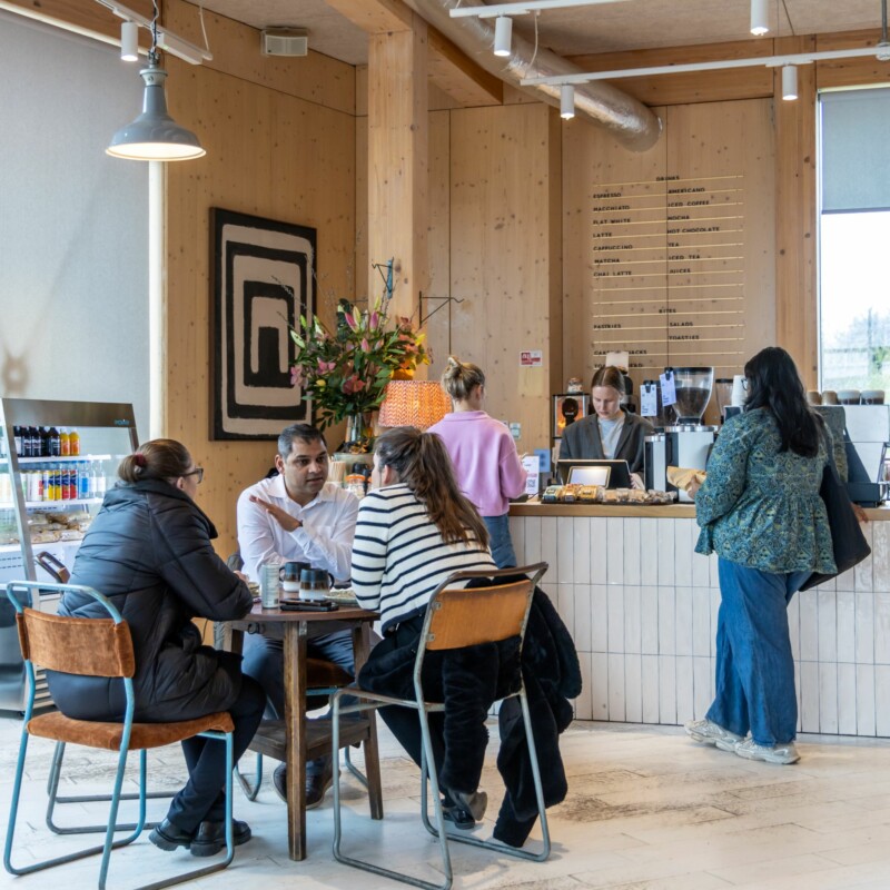 Photo of people chatting at a table in Arthur's Coffee House, Brent Cross Town. (Brent Cross Town)