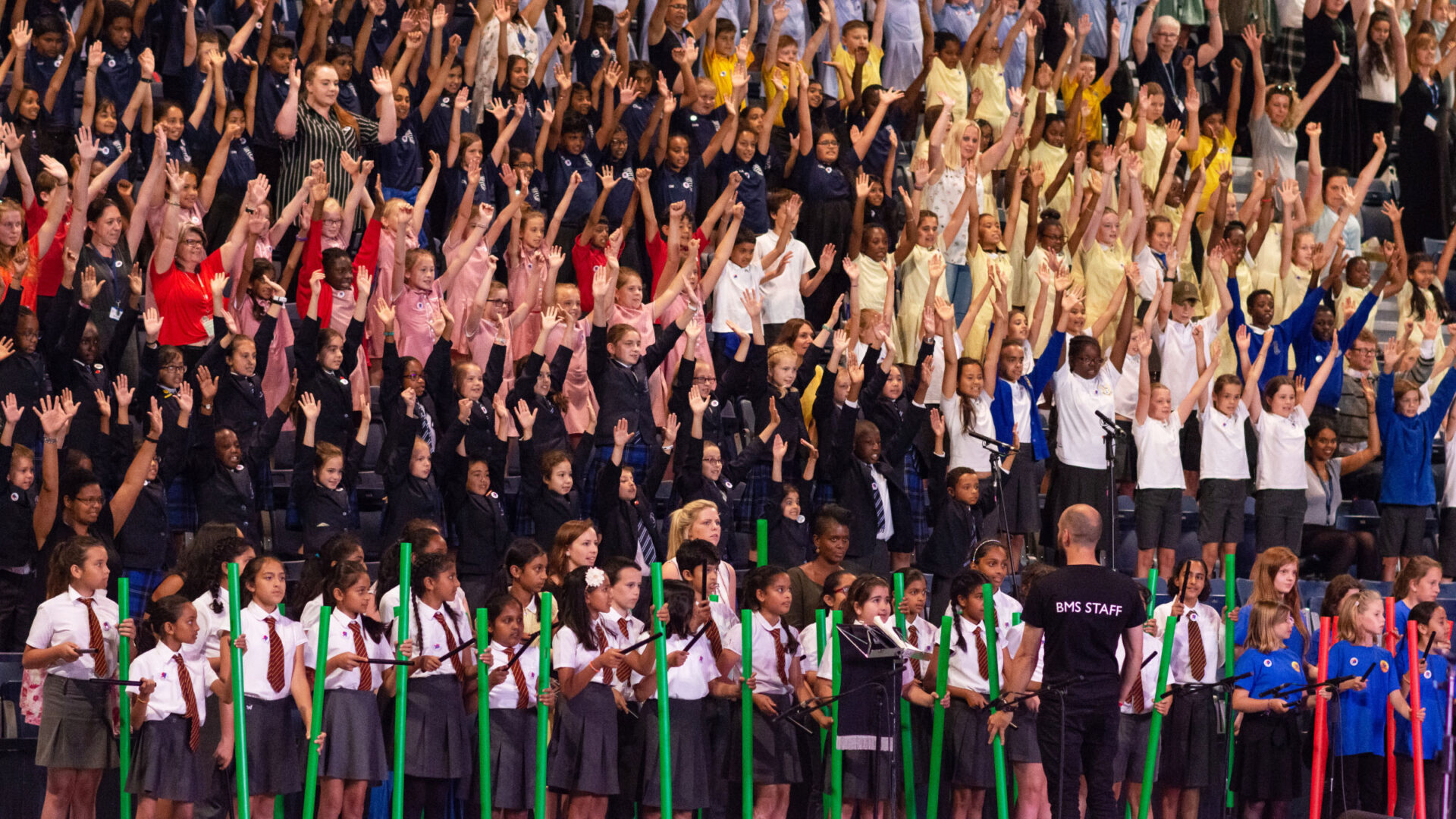 Large assembly of children taking part in music performance (Brent Cross Town)