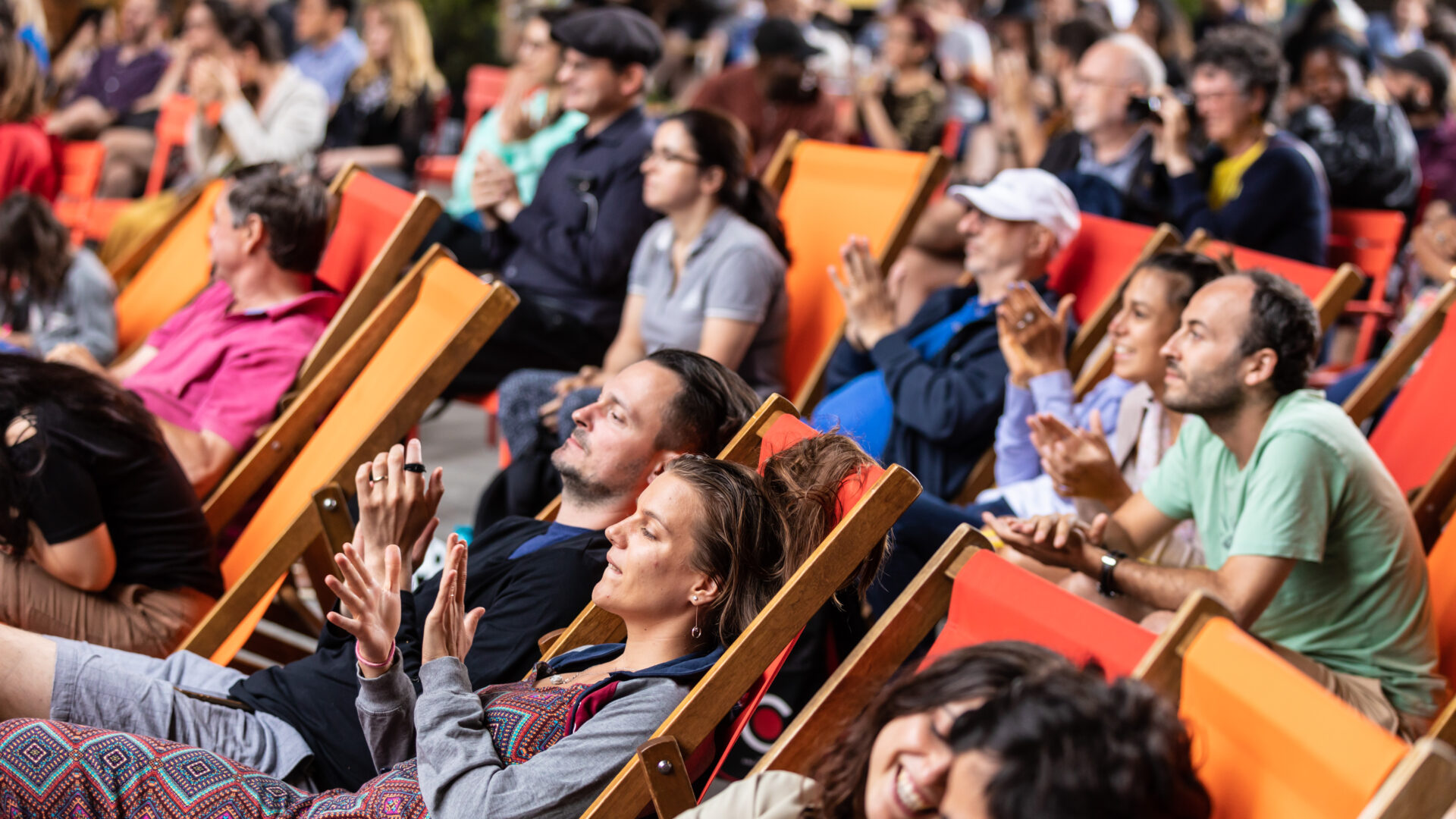 People enjoying a performance sitting in deckchairs (Brent Cross Town)