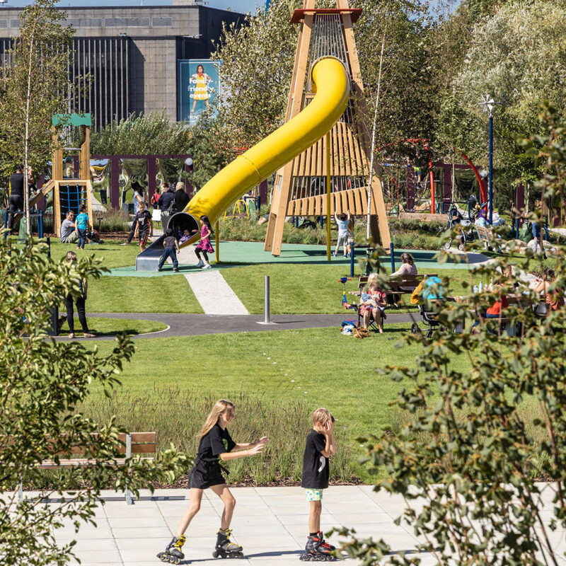 Photo of families enjoying the sun in Exploratory Park, Brent Cross Town.