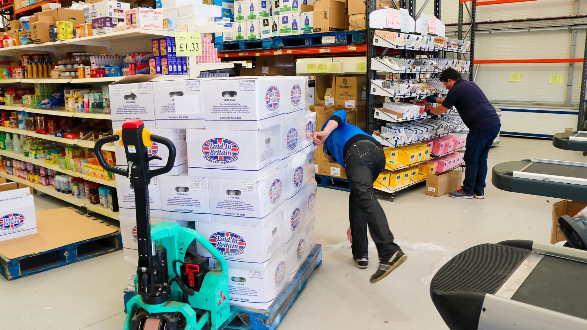 Kosher Outlet at Brent Cross Town, man moving stack of goods between aisles (Brent Cross Town)