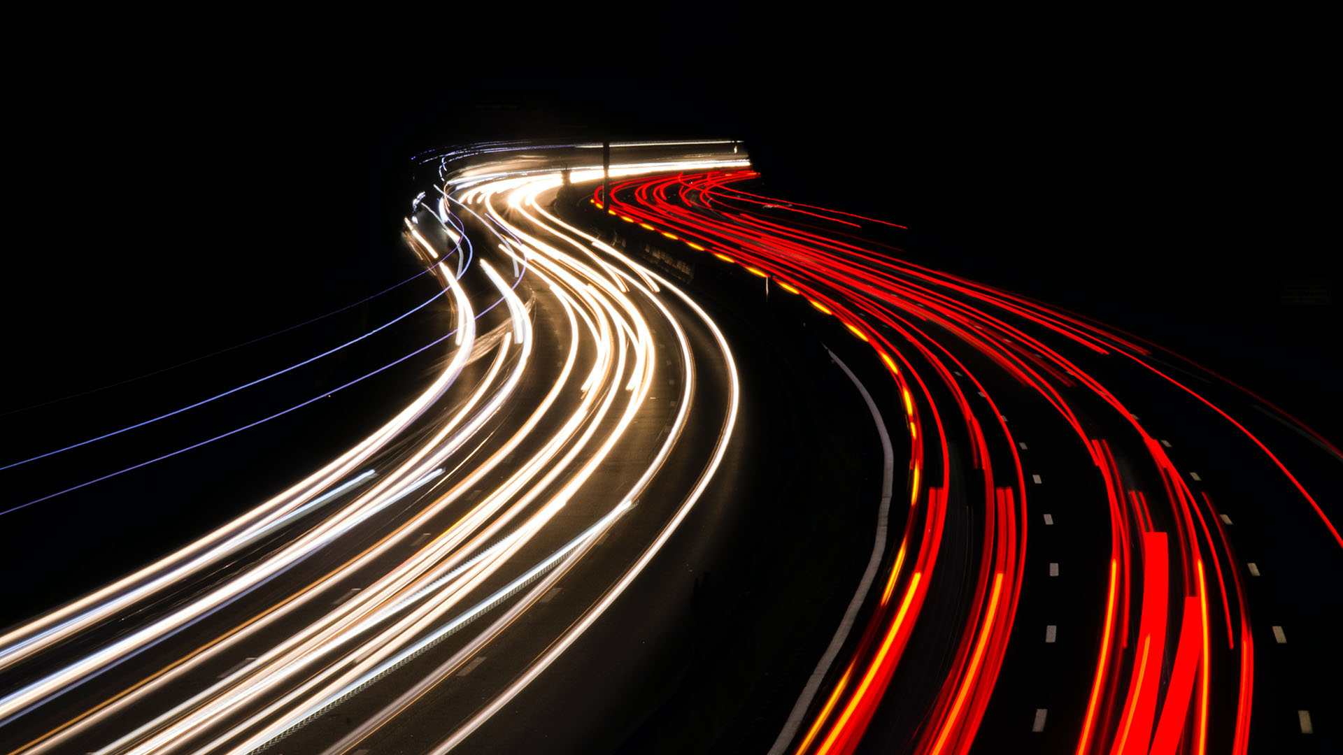 Slow-exposure photo of car lights on the M1 motorway at night. (Brent Cross Town)