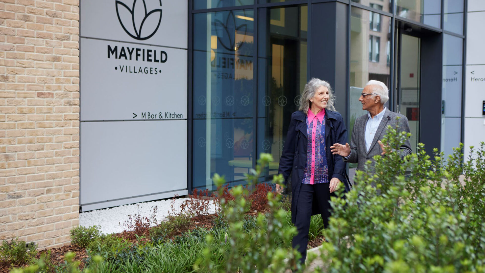 Couple walking past Mayfield Village, Brent Cross Town (Brent Cross Town)