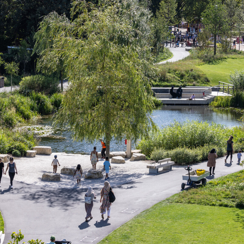 Visitors walking through Claremont Park on a sunny day in Brent Cross Town (Brent Cross Town)