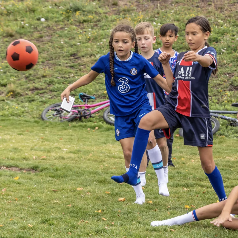 Local children playing football in Claremont Park, Brent Cross Town