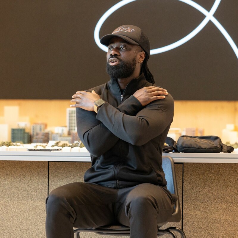 Photo of Philip Ankrah leading a chair exercise class at Brent Cross Town. (Brent Cross Town)