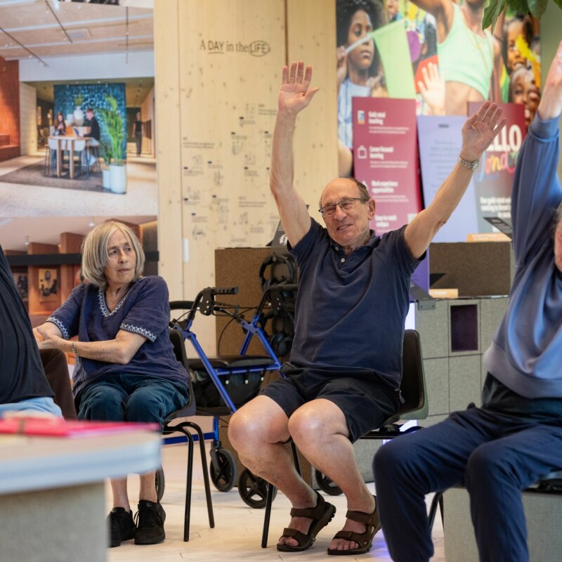 Photo of smiling people doing a chair exercise class in Brent Cross Town. (Brent Cross Town)