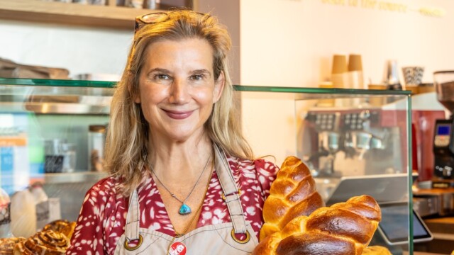 Photo of Tami from Karma Bakehouse in Brent Cross Town holding a loaf of bread. (Brent Cross Town)