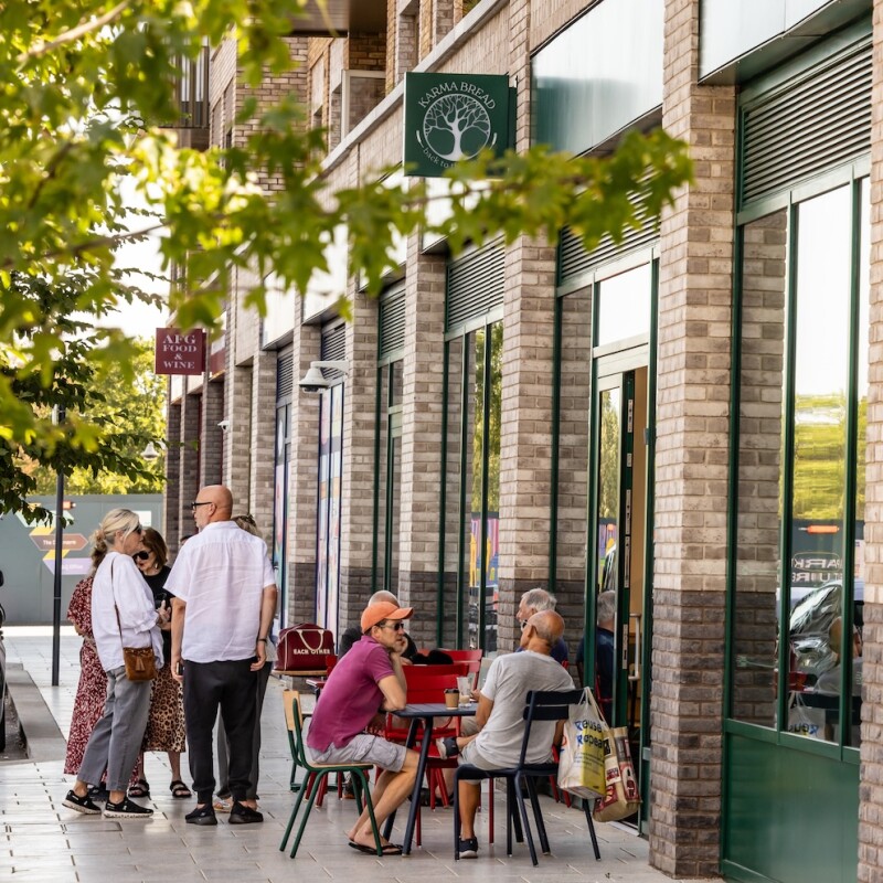 Photo of people sitting on the terrace outside Karma Bread Bakehouse in Brent Cross Town. (Brent Cross Town)