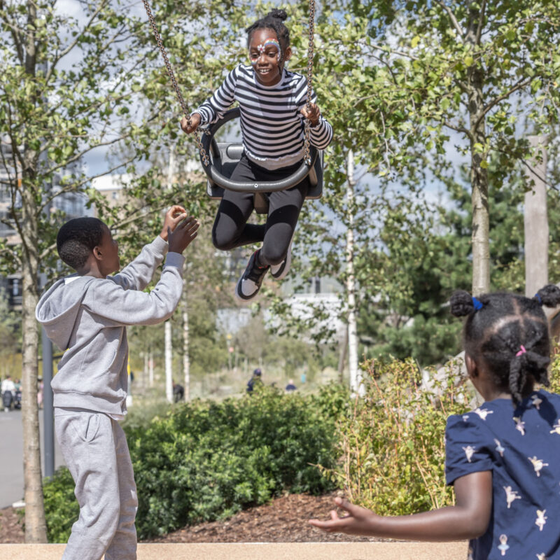 kids swinging in Claremont Park (Brent Cross Town)