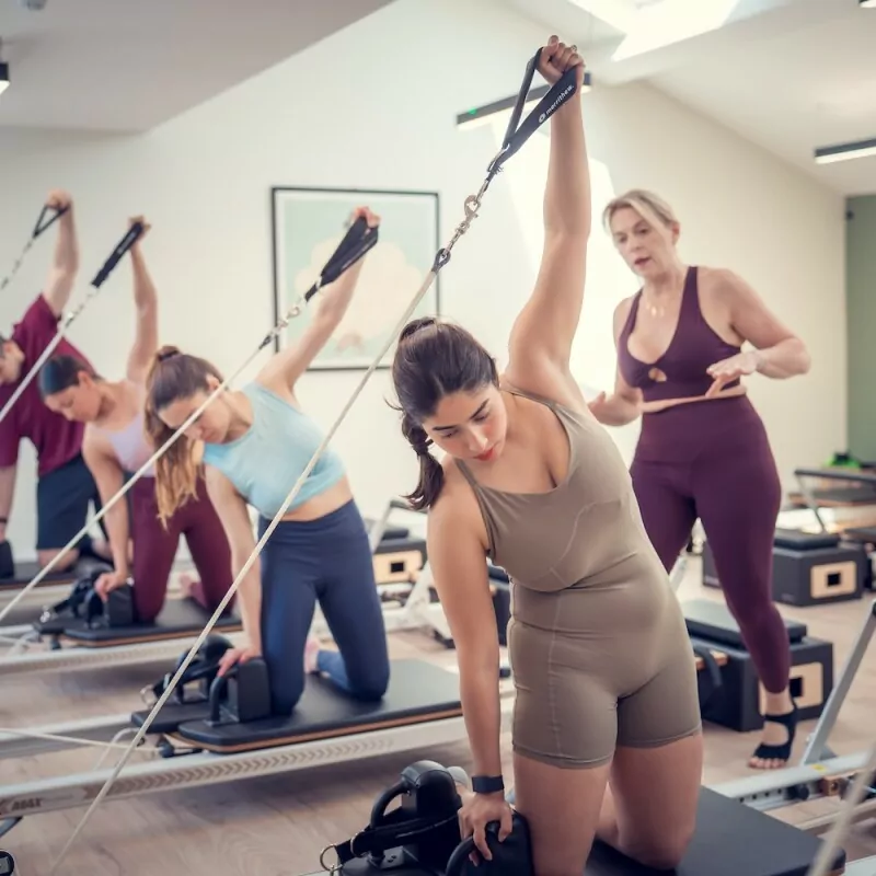 Photo of a mat pilates class taking place.