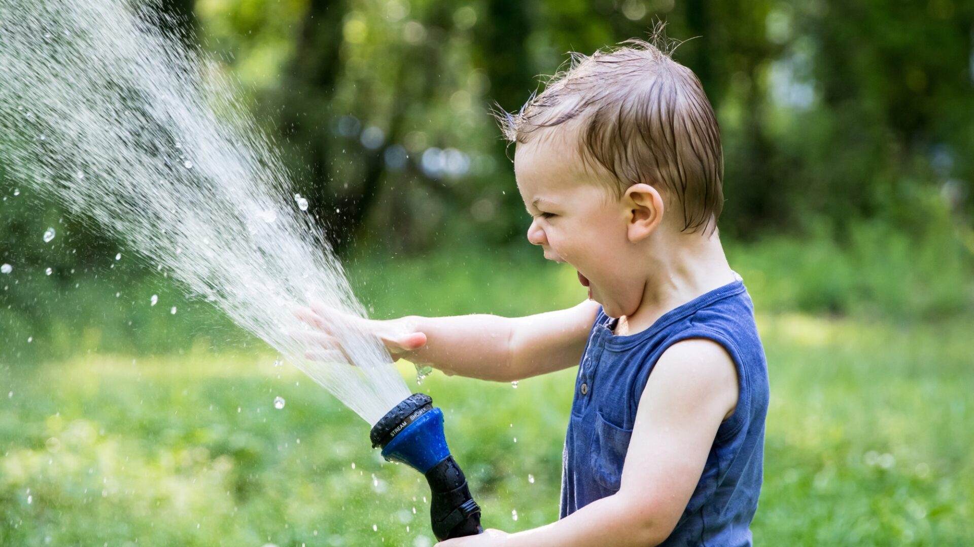 toddler playing with hose (Brent Cross Town)