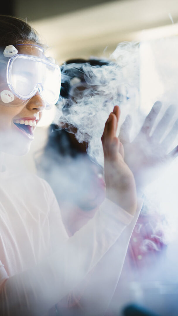 a pupil thrilled by the smoke coming off her science project (Brent Cross Town)