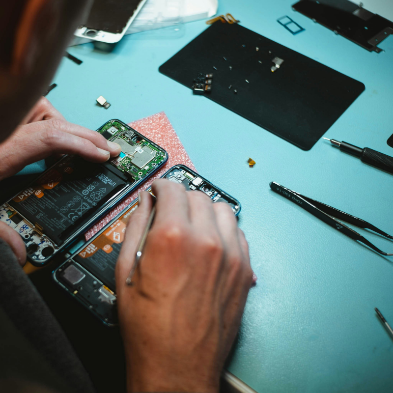 Hands fixing a hardrive from Screenshare who won a Brent Cross Town Community Fund 2023 (Brent Cross Town)