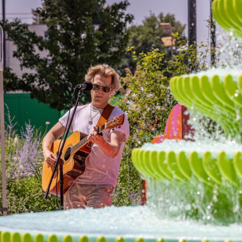 Photo of a musician playing guitar in Neighbourhood Square, Brent Cross Town. (Brent Cross Town)