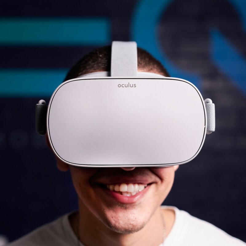 Photo of someone wearing a virtual reality headset and smiling. (Brent Cross Town)